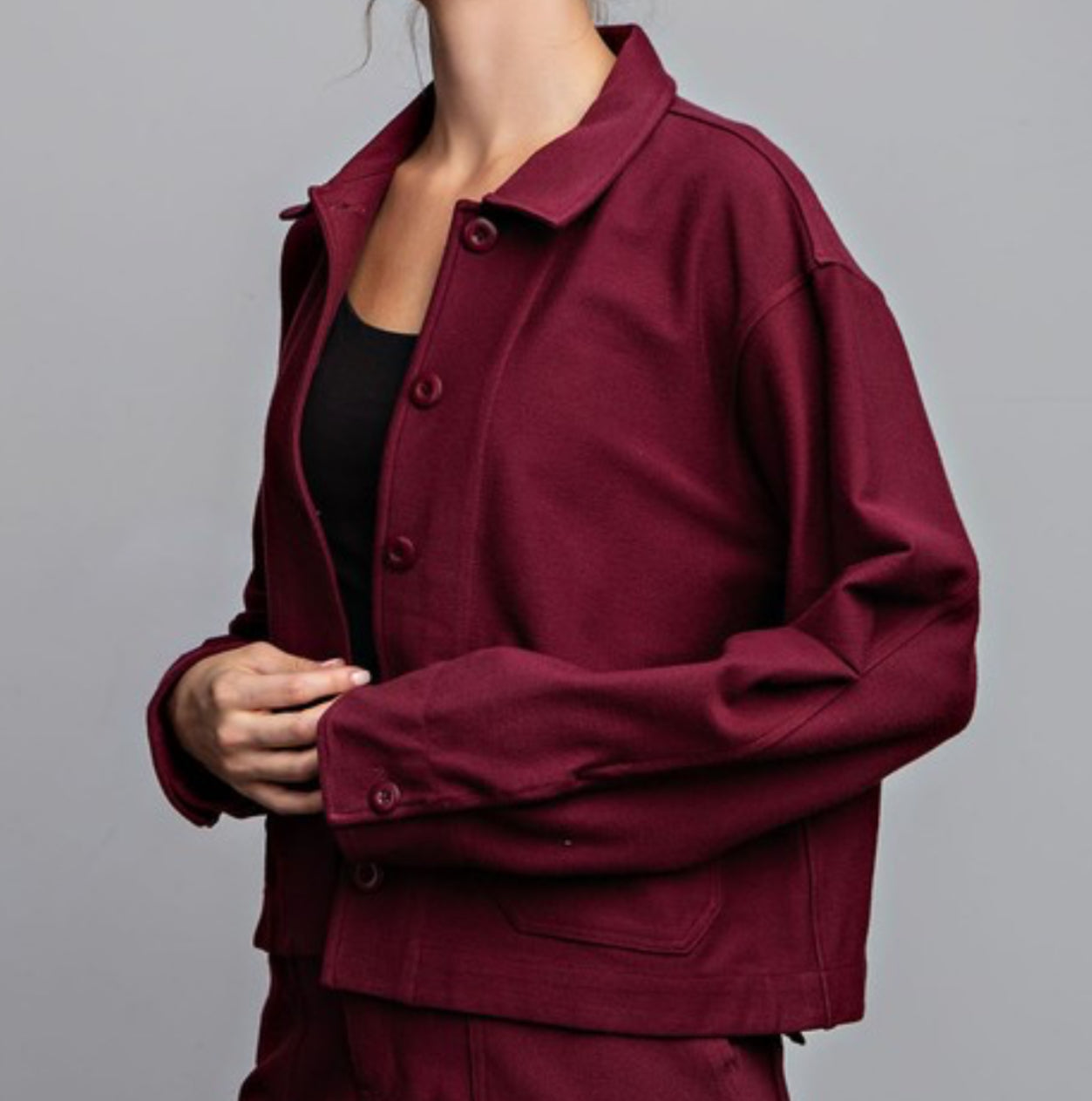 Model wearing Maybelle Cotton Stretch Relaxed Jacket in burgundy with button-up front and collar