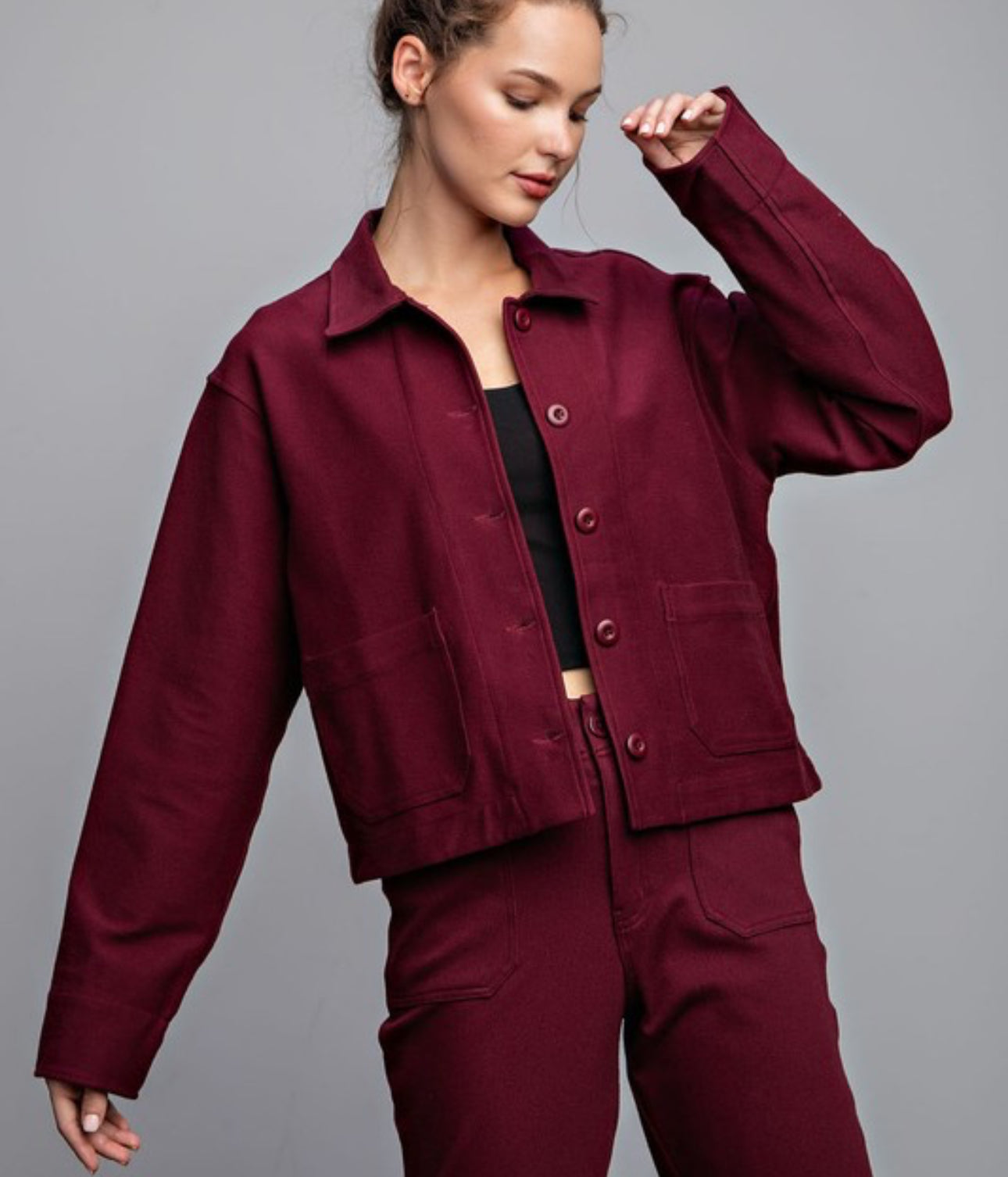 Model wearing Maybelle Cotton Stretch Relaxed Jacket in burgundy with button-up front and collar