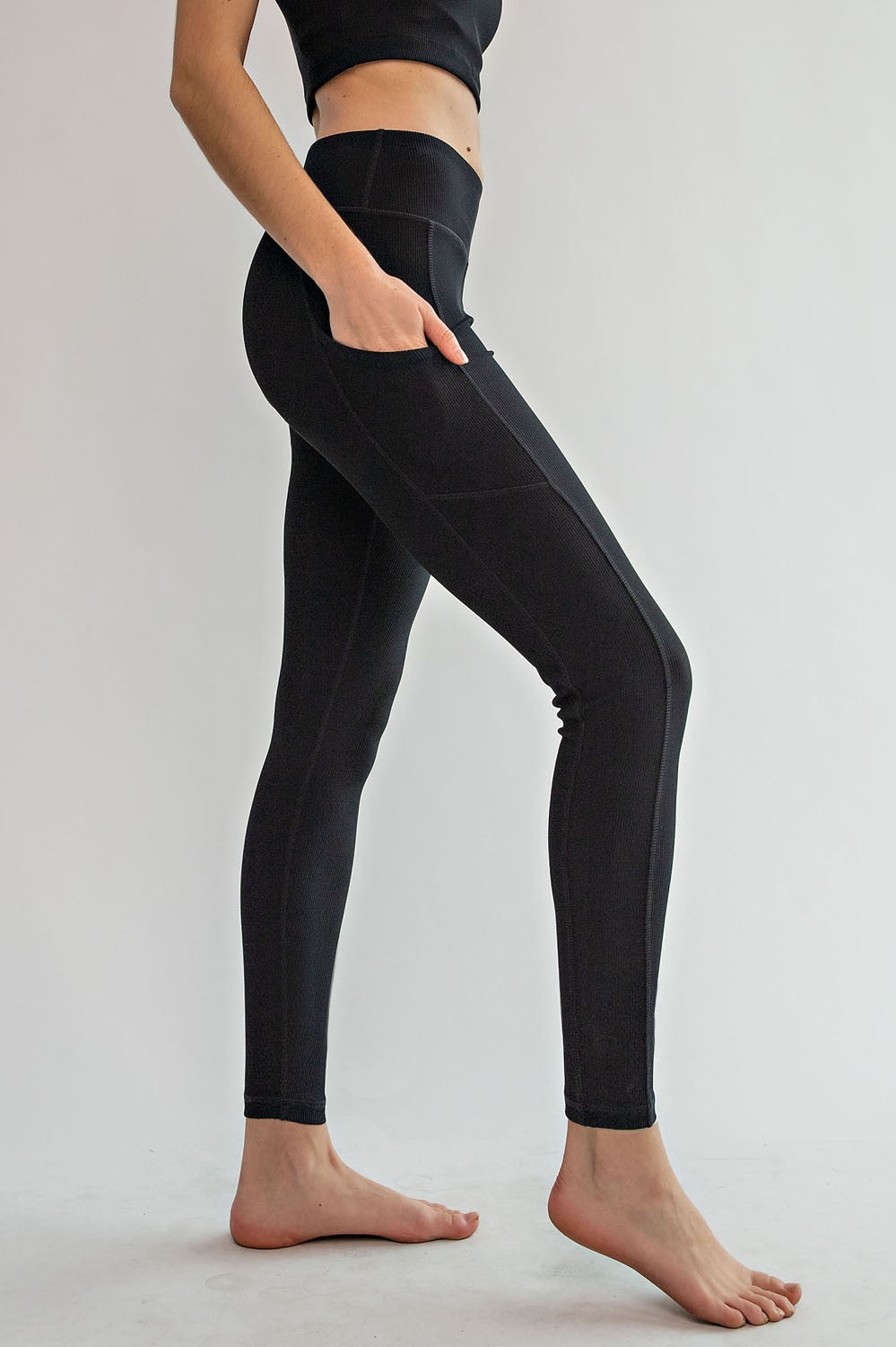 Model wearing Rally Ribbed Yoga Leggings – full length with side pockets