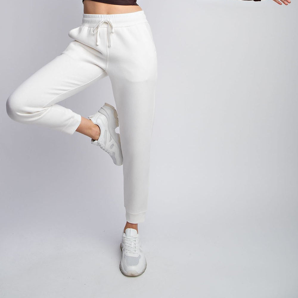 Model wearing Rebel French Terry Sweatpants with drawstring waist and side pockets

