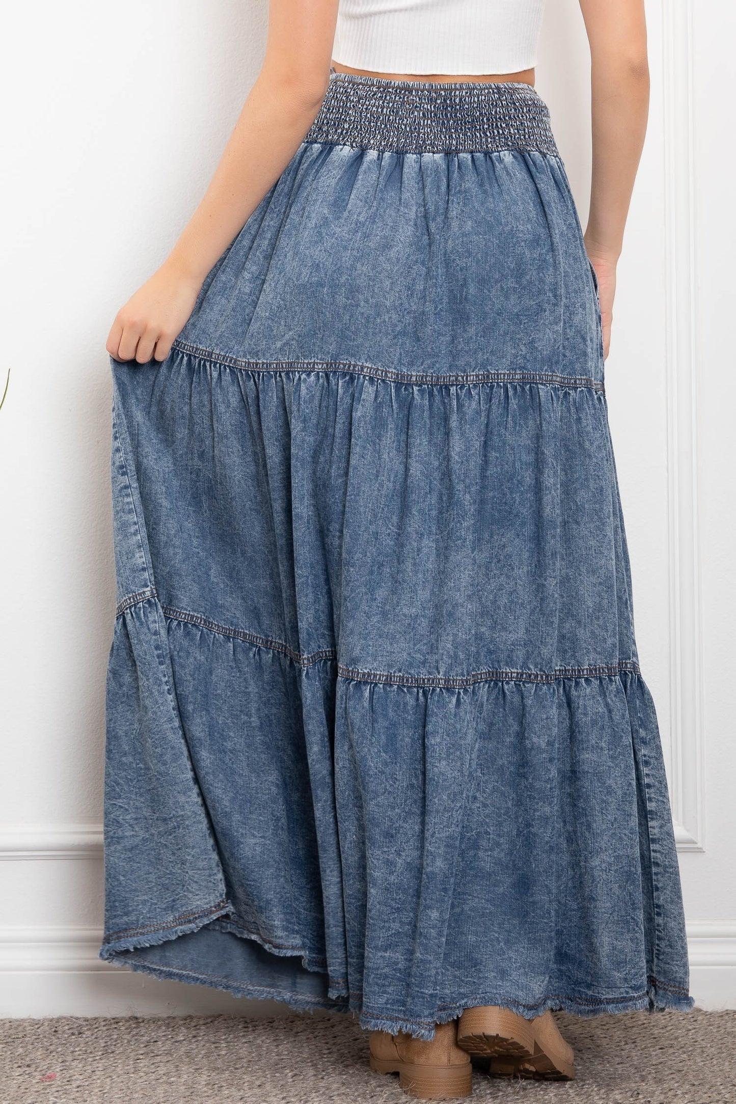 Woman wearing Bodi Denim Tiered Chambray Maxi Skirt with tiered silhouette and side pockets