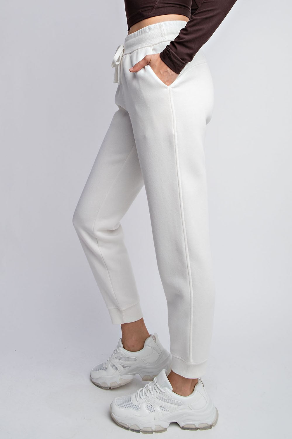 Model wearing Rebel French Terry Sweatpants with drawstring waist and side pockets

