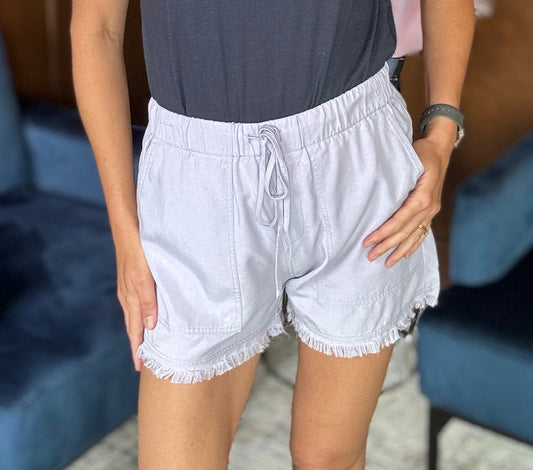 Model wearing Willa Tencel shorts with a casual tucked-in tee