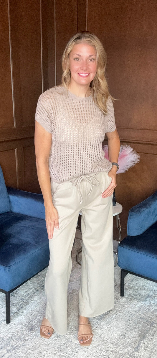 Evelyn wide leg sweatpants with exposed seam detail in soft fabric
Emma crochet short sleeve sweater with open weave detail



