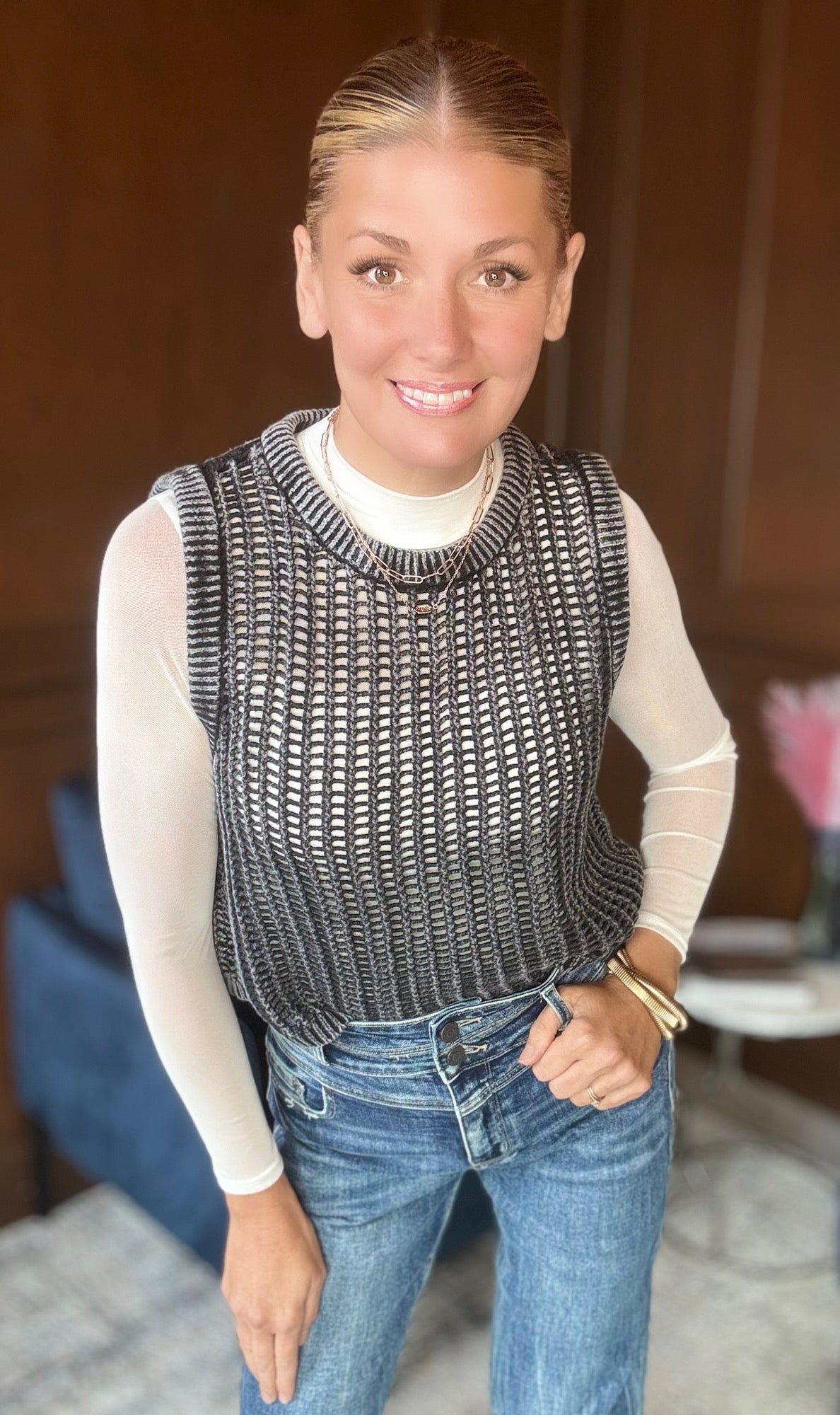 Black Yolanda fishnet sweater vest layered over bodysuit

