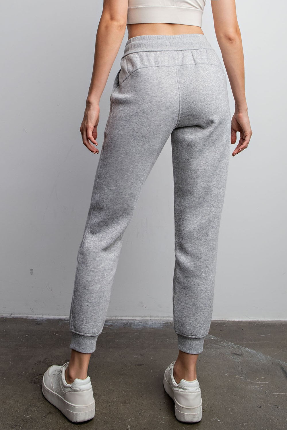 Model wearing Rebel French Terry Sweatpants with drawstring waist and side pockets

