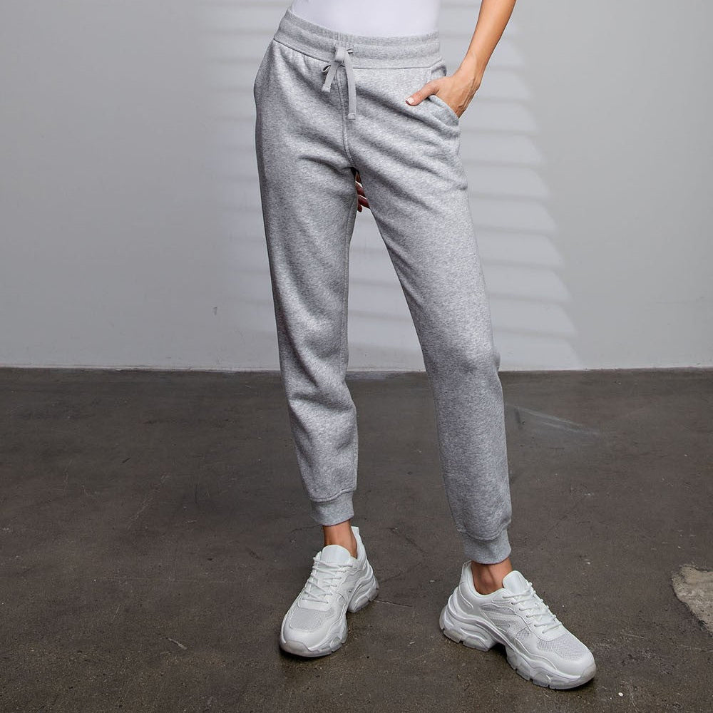 Model wearing Rebel French Terry Sweatpants with drawstring waist and side pockets


